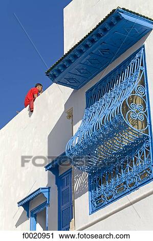 Stock Image - Tunisia, Sidi Bou Said, traditional window covered whith wire mesh. Fotosearch
