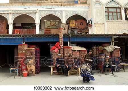 Stock Image - China, Xinjiang, kashgar, carpets merchant. Fotosearch