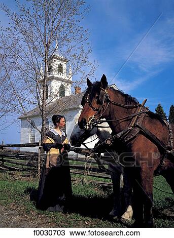 Stock Image - Canada, Ontario, Upper Canada Village, reconstitution historique, calèche et femme en costume d'époque. Fotosearch