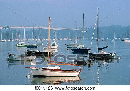 Stock Photograph - France, Brittany, Bénodet, the port and the bridge at sunrise. Fotosearch
