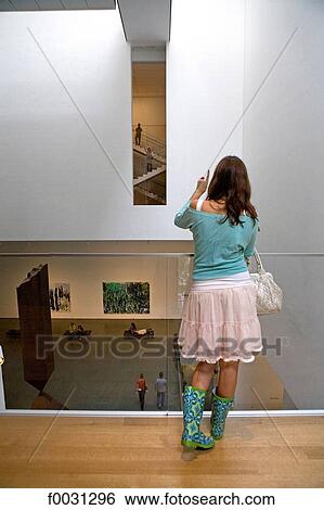 Stock Photograph - United States, New York, Manhattan, Museum of Modern Art, young woman in the museum. Fotosearch