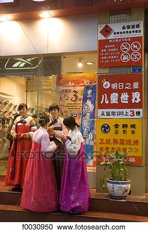 China, Sichuan, Chengdu, young girls in traditional dress by a shop View Large Photo Image Stock Image - China, Sichuan, Chengdu, young girls in traditional dress by a shop. Fotosearch