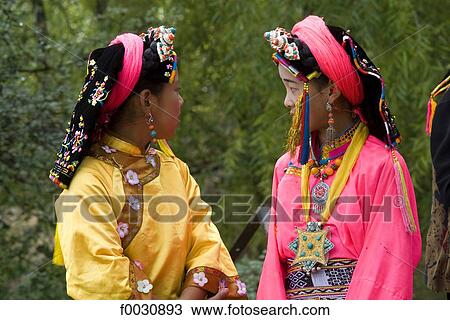 China, Sichuan, near Danba, Tibetan village festival, youg girls in colored traditional costume View Large Photo Image Stock Image - China, Sichuan, near Danba, Tibetan village festival, youg girls in colored traditional costume. Fotosearch