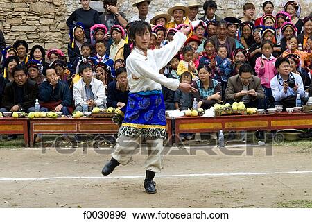 Stock Photo - China, Sichuan, near Danba, Tibetan village festival, dancer in traditional costume. Fotosearch