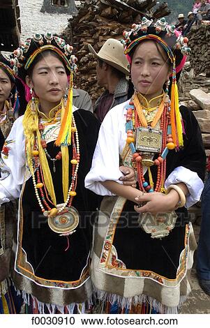 Stock Image - China, Sichuan, near Danba, village festival, woman wearing Tibetan traditional jewels. Fotosearch