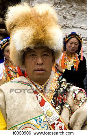 China, Sichuan, near Danba, village festival, portrait of a Tibetan wearing traditional costume View Large Photo Image Stock Photograph - China, Sichuan, near Danba, village festival, portrait of a Tibetan wearing traditional costume. Fotosearch