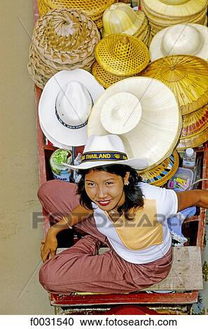 Thailand, Bangkok, Damnoen Saduak, floating market, hat seller View Large Photo Image Stock Image - Thailand, Bangkok, Damnoen Saduak, floating market, hat seller. Fotosearch