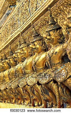 Stock Image - Thailand, Bangkok, emerald Buddha temple "Wat Phra Keo", row of statues on a facade of the royal chapel. Fotosearch