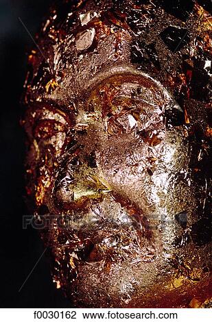 Stock Image - Thailand, Bangkok, Wat Po temple, Buddha statue head gilted with gold leaves offerings. Fotosearch