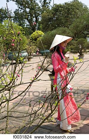 Picture - Vietnam, Hue, Imperial city, woman in traditional costume.. Fotosearch