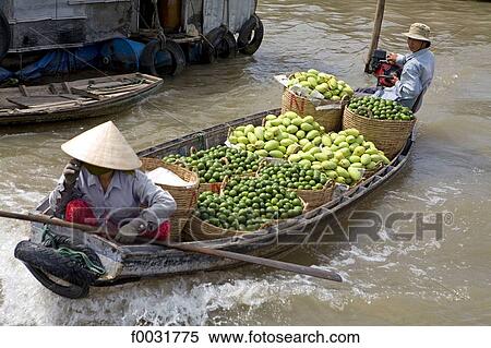 Stock Photography - Vietnam, Mekong delta, small boat carrying vegetables.. Fotosearch