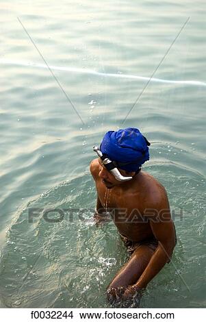 India, Punjab, Amritsar, the Golden Temple, sikh getting out of the pool of nectar. View Large Photo Image Picture - India, Punjab, Amritsar, the Golden Temple, sikh getting out of the pool of nectar.. Fotosearch
