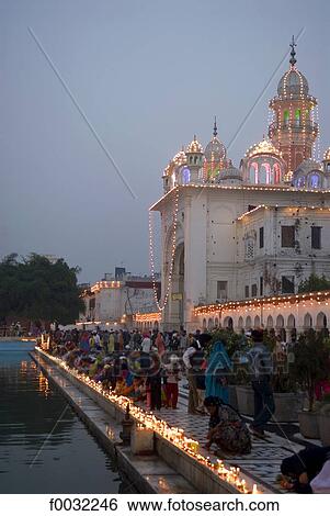 India, Punjab, Amritsar, the Golden Temple, lightning of candles by faithfuls during Guru Parab. View Large Photo Image Stock Photograph - India, Punjab, Amritsar, the Golden Temple, lightning of candles by faithfuls during Guru Parab.. Fotosearch