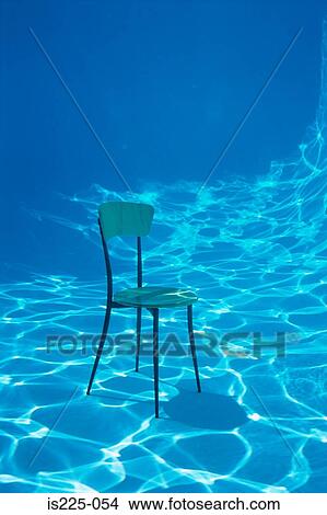 A chair on the bottom of a swimming pool View Large Photo Image Picture - A chair on the bottom of a swimming pool. Fotosearch