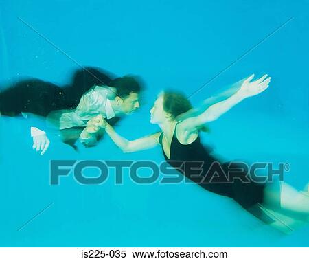 Stock Photography - A couple dancing in a swimming pool. Fotosearch