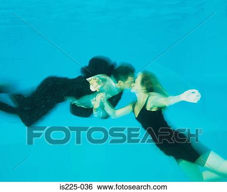 A couple kissing in a swimming pool View Large Photo Image Stock Photograph - A couple kissing in a swimming pool. Fotosearch