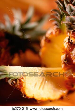 Stock Photography - A freshly cut slice of pineapple. Fotosearch