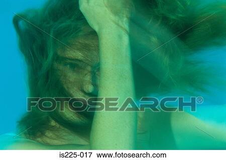 A girl under the water with her face covered with her hair View Large Photo Image Stock Photo - A girl under the water with her face covered with her hair. Fotosearch