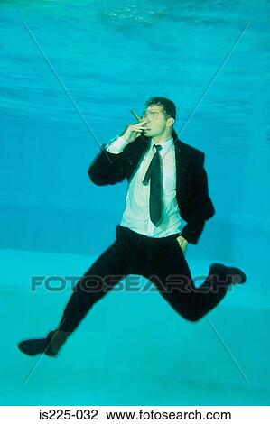 A man in a suit smoking under the water View Large Photo Image Stock Image - A man in a suit smoking under the water. Fotosearch