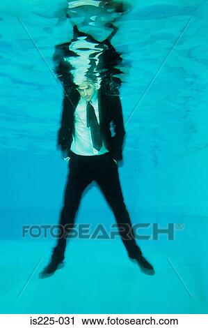 A man in a suit under the water View Large Photo Image Stock Image - A man in a suit under the water. Fotosearch