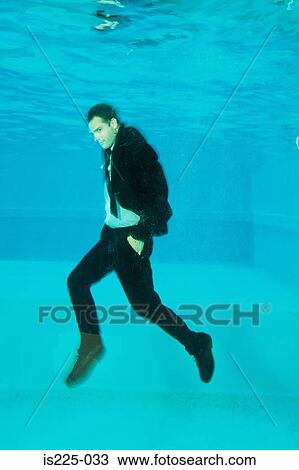 A man in a suit under the water View Large Photo Image Stock Image - A man in a suit under the water. Fotosearch