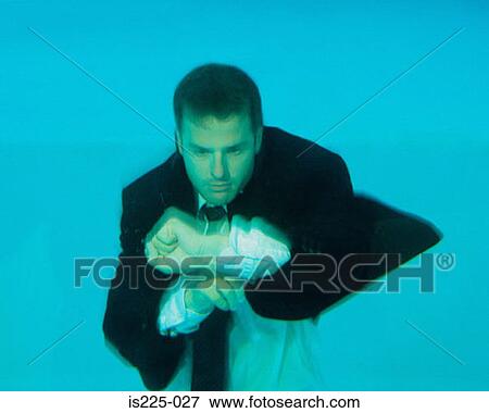 A man in a suit under the water View Large Photo Image Stock Photo - A man in a suit under the water. Fotosearch