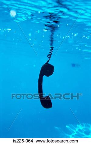 A telephone receiver in a swimming pool View Large Photo Image Picture - A telephone receiver in a swimming pool. Fotosearch
