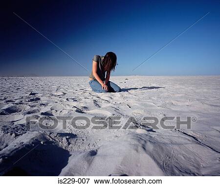 Stock Photo - A woman lost in the desert. Fotosearch