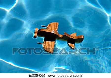 A wooden aircraft on a swimming pool View Large Photo Image Stock Photography - A wooden aircraft on a swimming pool. Fotosearch