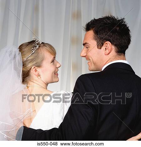 Bride and groom look at each other View Large Photo Image Stock Photo - Bride and groom look at each other . Fotosearch