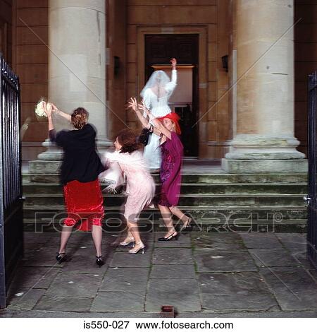 Bride throws the bouquet to hopeful friends View Large Photo Image Stock Photo - Bride throws the bouquet to hopeful friends. Fotosearch