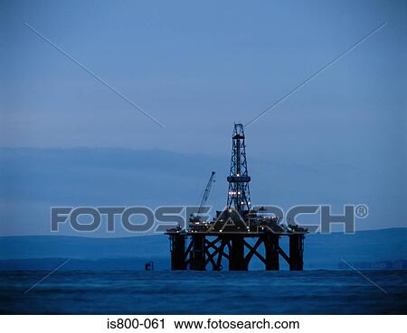 Stock Image - dawn, dusk, horizon, oil rig, sea. Fotosearch