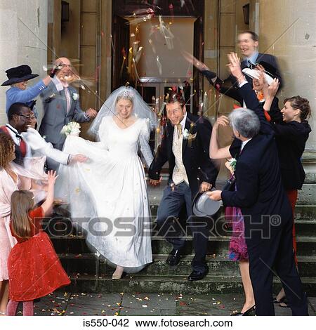 Family and friends throw confetti at the newly-weds View Large Photo Image Stock Image - Family and friends throw confetti at the newly-weds . Fotosearch