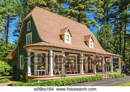 Picture - 1920s house with green cedar wood shingle siding and white trim bell roof. Fotosearch