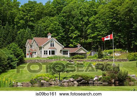 1990s Contemporary Victorian style country home with garden pond and Canadian flag View Large Photo Image Stock Image - 1990s Contemporary Victorian style country home with garden pond and Canadian flag. Fotosearch