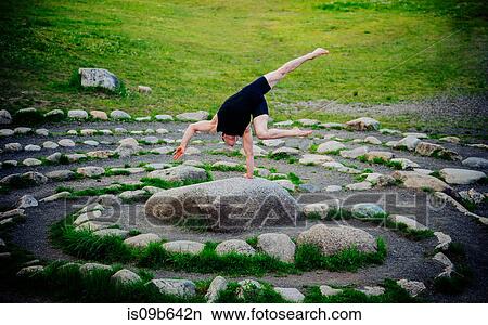 Acrobat performing on stone arrangement, Bainbridge, Washington, USA View Large Photo Image Picture - Acrobat performing on stone arrangement, Bainbridge, Washington, USA. Fotosearch