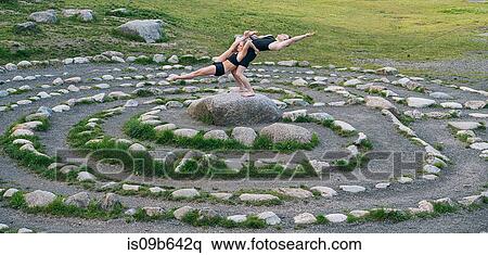 Acrobats performing on stone arrangement, Bainbridge, Washington, USA View Large Photo Image Stock Photography - Acrobats performing on stone arrangement, Bainbridge, Washington, USA. Fotosearch