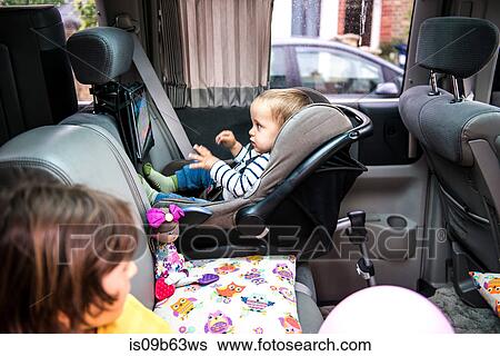 Baby and big brother watching movie in car View Large Photo Image Stock Photograph - Baby and big brother watching movie in car. Fotosearch