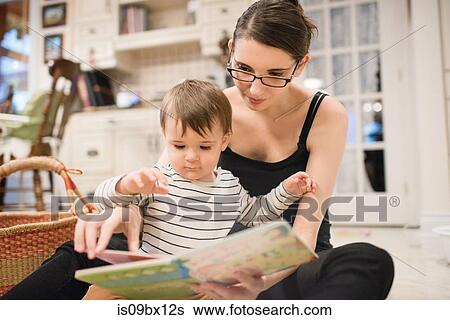 Baby boy and mother reading on floor View Large Photo Image Stock Photograph - Baby boy and mother reading on floor. Fotosearch