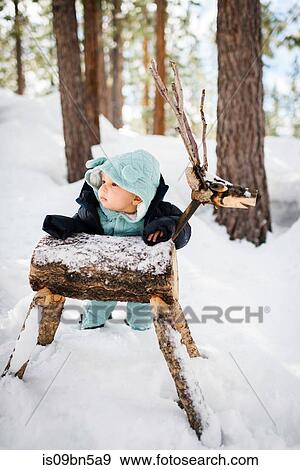 Baby boy ankle deep in forest snow leaning against wooden deer, South Lake Tahoe, California, USA View Large Photo Image Stock Photo - Baby boy ankle deep in forest snow leaning against wooden deer, South Lake Tahoe, California, USA. Fotosearch