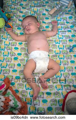 Baby boy asleep on bed View Large Photo Image Picture - Baby boy asleep on bed. Fotosearch