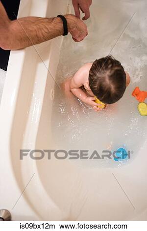 Baby boy enjoying bath time View Large Photo Image Picture - Baby boy enjoying bath time. Fotosearch
