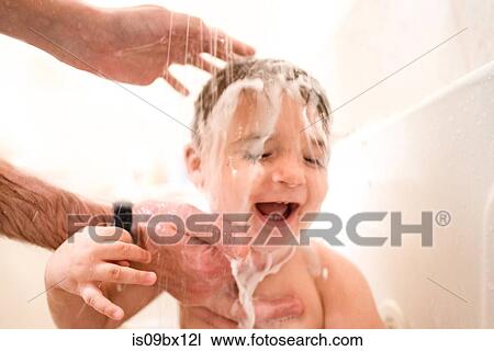 Baby boy enjoying bath time View Large Photo Image Stock Image - Baby boy enjoying bath time. Fotosearch