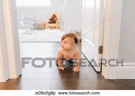Baby girl crawling through nursery doorway View Large Photo Image Stock Photography - Baby girl crawling through nursery doorway. Fotosearch