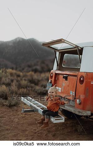 Baby girl happy balancing on bar of vehicle, Kennedy Meadows, California, US View Large Photo Image Stock Photography - Baby girl happy balancing on bar of vehicle, Kennedy Meadows, California, US. Fotosearch