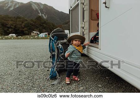 Stock Photograph - Baby hiker posing beside motorhome, Queenstown, Canterbury, New Zealand. Fotosearch
