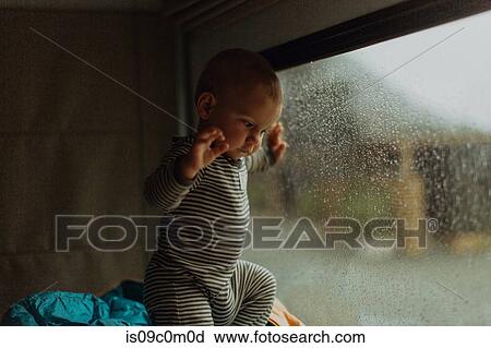 Stock Image - Baby playing in motorhome, Queenstown, Canterbury, New Zealand. Fotosearch