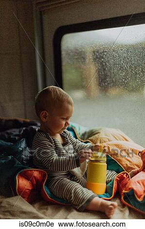 Stock Image - Baby playing in motorhome, Queenstown, Canterbury, New Zealand. Fotosearch