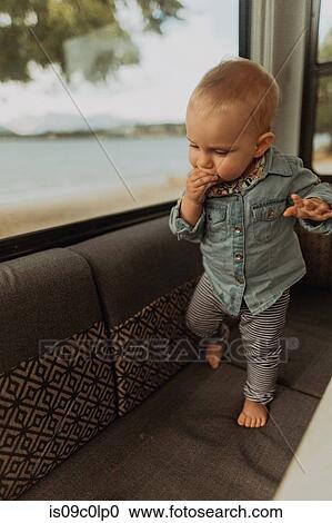 Baby walking on sofa in motorhome, Wanaka, Taranaki, New Zealand View Large Photo Image Stock Image - Baby walking on sofa in motorhome, Wanaka, Taranaki, New Zealand. Fotosearch