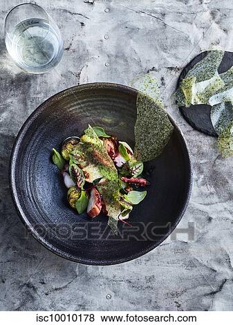 Stock Photo - BBQ octopus with wakame and potato. Fotosearch